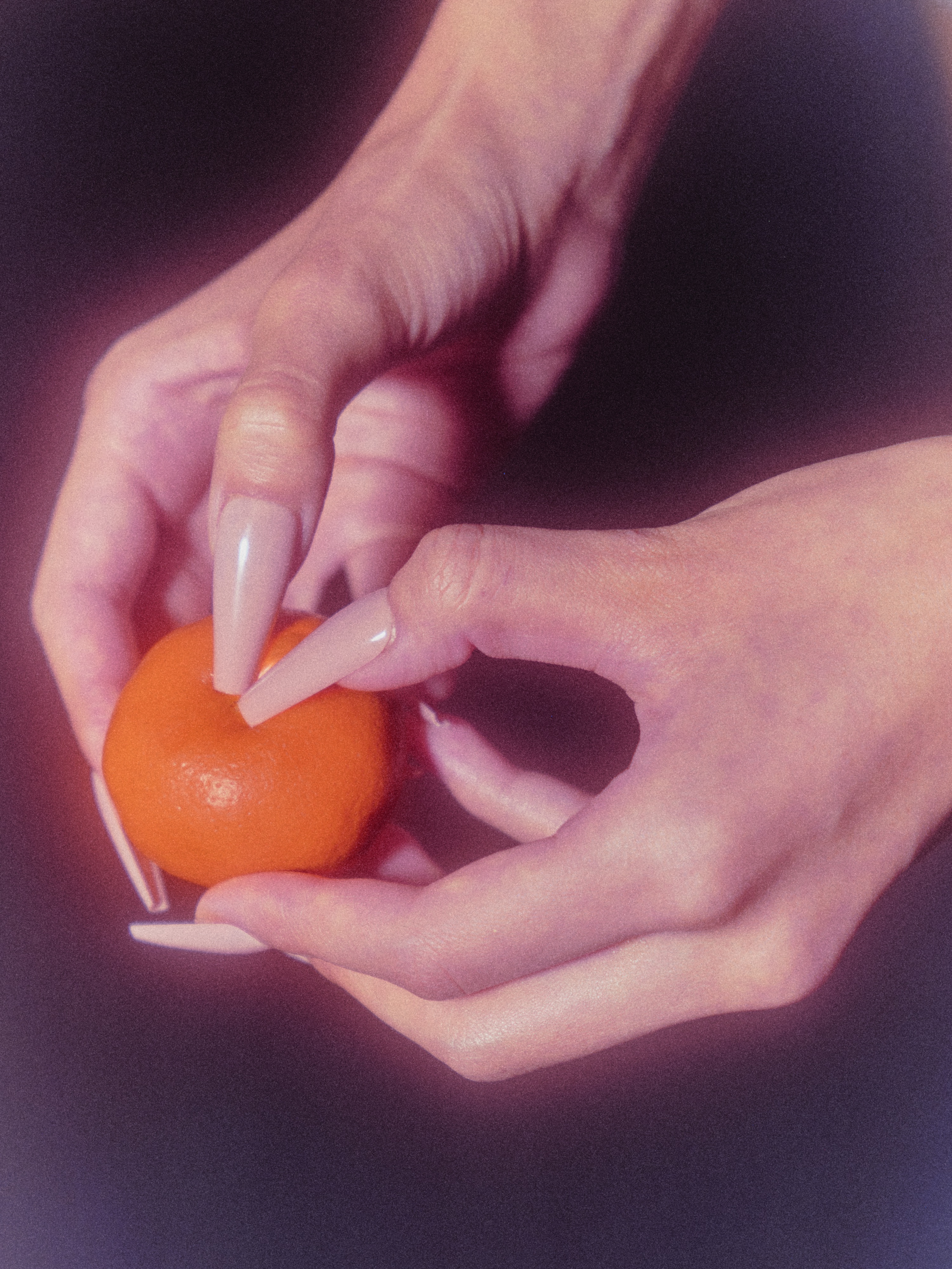 Tactile hand holding orange